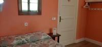 A bed or beds in a room at Hostal San Martin
