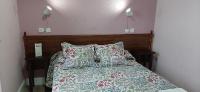 A bed or beds in a room at Hostal San Martin