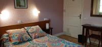 A bed or beds in a room at Hostal San Martin