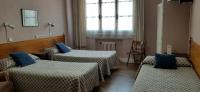 A bed or beds in a room at Hostal San Martin