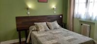 A bed or beds in a room at Hostal San Martin