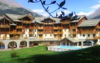 a large building with a swimming pool in front of it at Les Alpages De Val Cenis by Resid&amp;co in Lanslebourg-Mont-Cenis