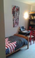 a bedroom with a bed and a desk with a laptop at L&#39;appartement du Haut Plessis in Blois