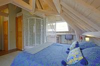 a bedroom with a large bed in a attic at Les gerbes in Arras-en-Lavedan