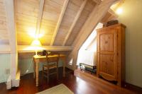 a room with a table and a lamp in a attic at Les gerbes in Arras-en-Lavedan