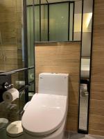 a bathroom with a white toilet in a room at Hotel Midtown Richardson in Taipei