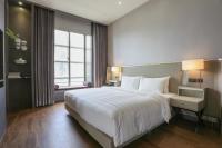 a hotel room with a large bed and a window at City Suites - Taipei Nandong in Taipei