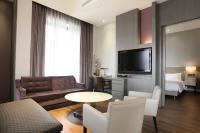 a living room with a couch and a tv at City Suites - Taipei Nandong in Taipei
