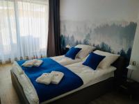 Łóżko lub łóżka w pokoju w obiekcie Apartament Złota Brama