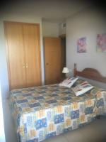 A bed or beds in a room at Punta Prima 229