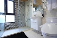 a bathroom with a toilet and a glass shower at Ji Ye Jing Zhan B&amp;B in Ji&#39;an