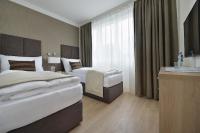 Postel nebo postele na pokoji v ubytování Apollo Hotel Bratislava