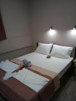 A bed or beds in a room at Athanasia inn II