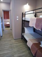 A bed or beds in a room at Athanasia inn II