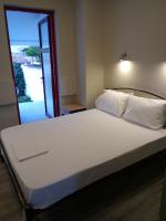 A bed or beds in a room at Athanasia inn II