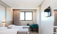 a hospital room with two beds and a table at Porto Kaeté Hotel in Maceió