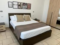 A bed or beds in a room at Torre dei Mori Boutique Rooms B&B