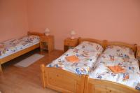 A bed or beds in a room at Penzion Chalupka
