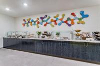 ein Restaurant mit einer Theke, an deren Wand bunte Teller hängen in der Unterkunft Holiday Inn - Columbus by IHG in Columbus