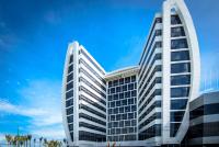 Un edificio de oficinas alto con un cielo azul al fondo. en Wyndham Manta Sail Plaza Hotel and Convention Center, en Manta
