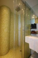 a bathroom with a shower with a glass door at Hotel Papa Whale-Kaohsiung Formosa Boulevard in Kaohsiung