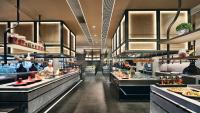a restaurant with a buffet line with people preparing food at InterContinental Xi'an North by IHG in Xi'an
