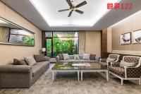 a living room with a couch and a table at Great Roots Forestry Spa Resort in Sanxia