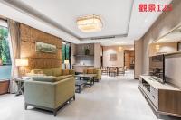 a living room with couches and a dining room at Great Roots Forestry Spa Resort in Sanxia