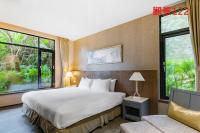 a hotel room with a bed and a couch at Great Roots Forestry Spa Resort in Sanxia