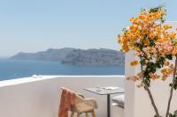 a room with a table and flowers on a white wall at Aspaki by Art Maisons in Oia