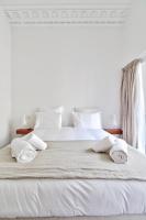 a white bed with two towels on top of it at Modern Apt 3BDR&#47;3BATH - Louvre Museum&#47;Tuileries in Paris