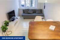Televízia a/alebo spoločenská miestnosť v ubytovaní Apartamenty Zacisze