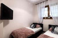 Posteľ alebo postele v izbe v ubytovaní Apartamenty Tatrzańskie Turnie