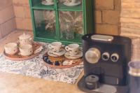 a cups and saucers on a counter with a coffee maker at The Melegran in Rovinj