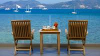 a table and two chairs with a table and water at Amari Phuket in Patong Beach