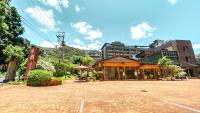 a building on a brick road in a city at Yage Hotspring House in Jiaoxi