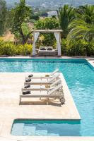 a pool with a row of chaise lounges and a gazeb at Can Jaume by Ocean Drive in Ibiza Town