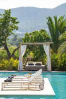 a resort with a pool with a bed and a swing at Can Jaume by Ocean Drive in Ibiza Town