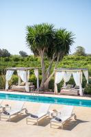 a pool at a resort with chaise lounge chairs and trees at Can Jaume by Ocean Drive in Ibiza Town