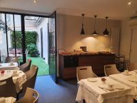 a restaurant with tables and chairs and a counter at Hôtel Harvey in Paris