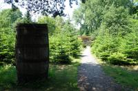 a wooden barrel on a path in a forest at Levaltipis in Saint Gatien des Bois