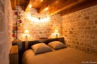 a bedroom with a bed with two pillows and two lamps at Le Mas des Mathes, Chambres d&#39;hôtes, Studios in Les Mathes