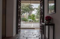 a hallway with an open door with a dog in the yard at La Almoraima Hotel in Castellar de la Frontera