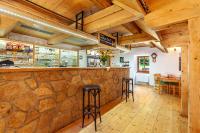 a bar in a restaurant with a stone wall at Penzion Bačalský mlýn in Morašice