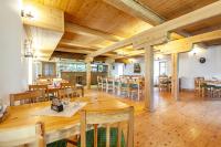 a large dining room with wooden tables and chairs at Penzion Bačalský mlýn in Morašice