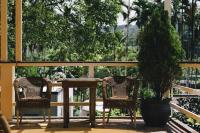 a table and two chairs and a potted tree on a porch at Monet Garden Coffee Farm in Chinan