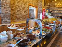 a buffet line with different types of food on it at Hotel Kamomil in Durrës