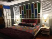 a bedroom with a bed with a colorful accent wall at Baan Baimai Boutique Room in Phra Nakhon Si Ayutthaya