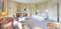 a bedroom with a bed and a fireplace at Hôtel Villa Navarre in Pau