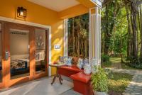 a porch with a bench and a bed in a room at Taj Holiday Village Resort & Spa, Goa in Candolim